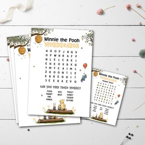 May include: A stack of Winnie the Pooh themed word search activity sheets. The sheets feature a word search grid, illustrations of Pooh and friends, and the text "Winnie the Pooh WORDSEARCH". The sheets are decorated with bees and honeycombs.