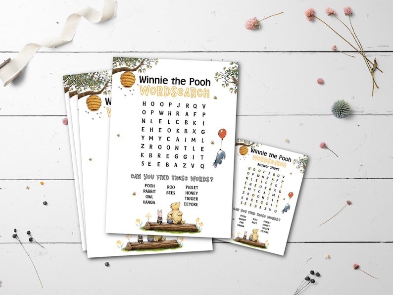 May include: A stack of Winnie the Pooh themed word search activity sheets. The sheets feature a word search grid, illustrations of Pooh and friends, and the text "Winnie the Pooh WORDSEARCH". The sheets are decorated with bees and honeycombs.