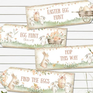 May include: Four printable Easter egg hunt signs with bunny illustrations and floral accents. The signs read "Easter Egg Hunt", "Egg Hunt this way", "Hop this way", and "Find the Eggs".