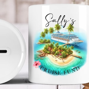 May include: White ceramic money bank with a tropical island and cruise ship design. The bank features the text "Sally's Cruise Fund" in black script. A slot for inserting money is visible on the side.