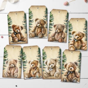May include: A collection of eight rectangular gift tags with a watercolor illustration of a teddy bear. Each tag features a different bear, with varying shades of brown and beige. Green pine trees frame the bear on a light brown background.