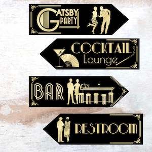May include: Four black and gold arrow signs with gold art deco designs and text. The signs read "Gatsby Party", "Cocktail Lounge", "Bar", and "Restroom".