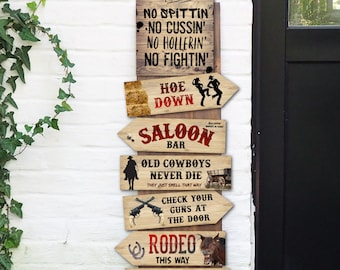 May include: A set of six wooden signs with red and white text and illustrations. The signs are shaped like arrows and point in different directions. The signs read: "Hoe Down Rules", "Hoe Down", "Saloon Bar", "Old Cowboys Never Die", "Check Your Guns At The Door", and "Rodeo This Way".