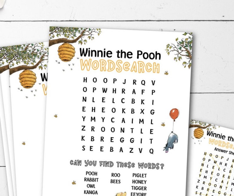 May include: A white paper featuring a Winnie the Pooh word search puzzle. The title "Winnie the Pooh WORDSEARCH" is in yellow and black. The puzzle includes illustrations of a beehive, bees, and Eeyore with a red balloon.