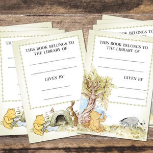 May include: Several cream-coloured bookplates featuring a Winnie the Pooh design. Each plate has the text "THIS BOOK BELONGS TO THE LIBRARY OF" and "GIVEN BY". Illustrations include Pooh, Piglet, Eeyore, and Rabbit.