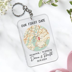 May include: A clear acrylic keychain with a map of New York City and the text "OUR FIRST DATE"  40.66174°N | 73.97192°W Donna & Ronald 01.19.2024.