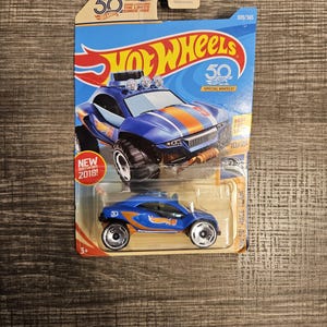May include: A blue and orange Hot Wheels toy car with special wheels. The car is on a blue and orange card with the words "Hot Wheels" and "50th Anniversary" printed on it. The card also has the number 309/365 printed on it.