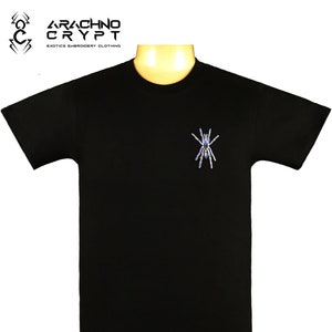 May include: Black t-shirt with a blue and yellow embroidered spider on the front. The shirt has the text "Arachno Crypt" and "Exotics Embroidery Clothing" on the top.
