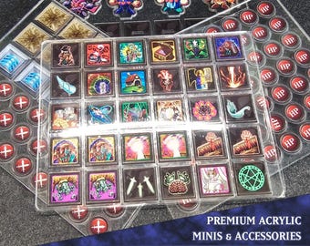 Peut inclure: Un coffret de rangement en acrylique transparent avec une grille de 36 compartiments, chacun contenant une figurine miniature ou une pièce de jeu. Le coffret comprend également un ensemble de jetons HP. Le texte "PREMIUM ACRYLIC MINIS & ACCESSORIES SPECIAL PACK 2" est imprimé au bas du coffret.