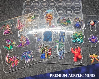Puede incluir: Miniaturas de acrílico transparente de varios monstruos, expuestas en láminas de plástico transparente. Las figuras son de colores brillantes y detalladas, con el texto "PREMIUM ACRYLIC MINIS" y "MONSTER PACK 12".
