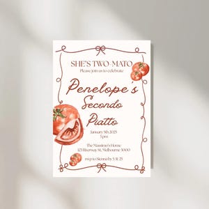 May include: A rectangular invitation with a watercolor illustration of tomatoes. The text reads "SHE'S TWO-MATO" and "Penelope's Secondo Piatto" with event details. The invitation is framed with a brown decorative border.