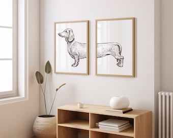 May include: Two framed illustrations of a dachshund dog in a minimalist interior setting. The illustrations are in black and white and feature the dog in a side profile. The illustrations are hanging on a white wall above a wooden shelf with a white ceramic vase and books.