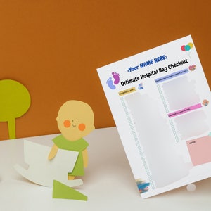 May include: A white checklist with the title "Ultimate Hospital Bag Checklist" and the text "<Your Name Here>" at the top. The checklist is divided into two sections: "Checklist for you" and "Checklist for your family". There are also some colorful illustrations of baby footprints, balloons, and a baby.