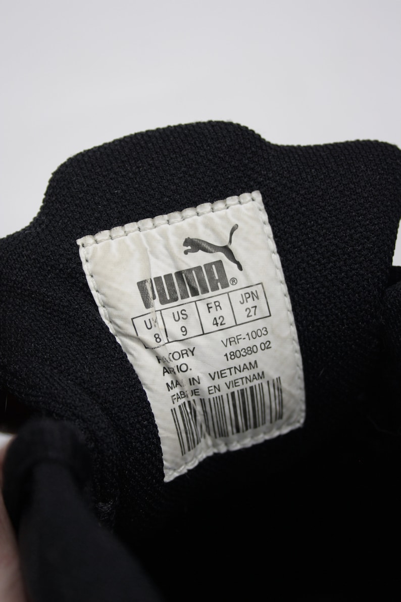 K&ouml;nnte beinhalten: Ein wei&szlig;es Etikett mit schwarzem Text und einem Puma-Logo. Das Etikett zeigt die Schuhgr&ouml;&szlig;e in UK, US, FR und JPN Gr&ouml;&szlig;en. Das Etikett zeigt auch "Factory Ario." und "Made in Vietnam, Fabriqu&eacute; en Vietnam".