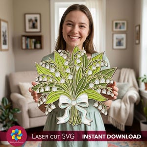 May include: A wooden laser-cut bouquet of lily of the valley flowers. The bouquet features white flowers, green leaves, and a light blue ribbon. The text "LASER CUT SVG INSTANT DOWNLOAD" is at the bottom.