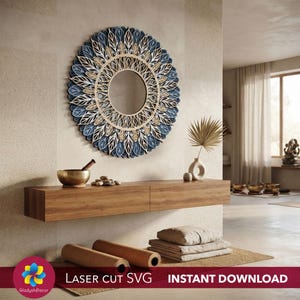 May include: A circular wall mirror featuring a layered, laser-cut design with blue and natural wood-toned leaf motifs arranged in a radial pattern. The mirror has a central circular glass pane surrounded by intricate, overlapping wooden cutouts.