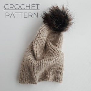 May include: A beige crochet beanie with a brown faux fur pom pom. CROCHET PATTERN is written above the beanie.
