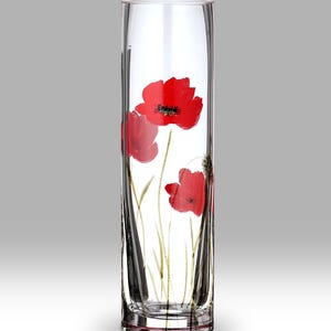 May include: A clear, rectangular glass vase with a painted floral design. The vase features three red poppy flowers with green stems and leaves. The vase is approximately 25 cm tall.