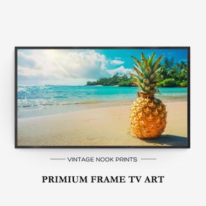 May include: A framed print featuring a vibrant pineapple on a sandy beach with turquoise water and a sunny sky. The print is labeled "VINTAGE NOOK PRINTS" and "PRIMIUM FRAME TV ART".