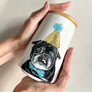 A cremation urn with a hand-painted Pet portrait