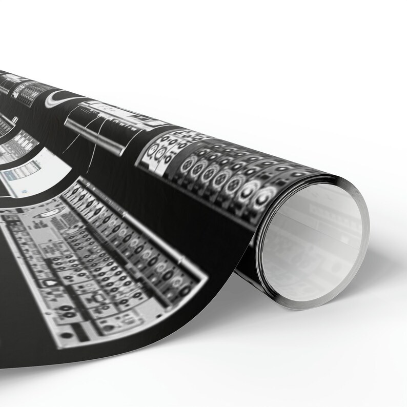 May include: A black and white image of a rolled up poster featuring a close-up of a vintage audio mixing board with knobs and dials.