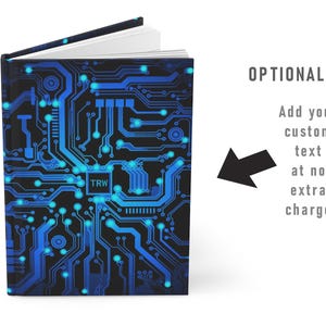 May include: A blue and black notebook with a circuit board design. The text "TRW" is visible on the cover.