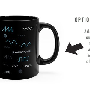May include: Black ceramic mug with a white design of various waveforms and the text "@MODULAR_JOHN".