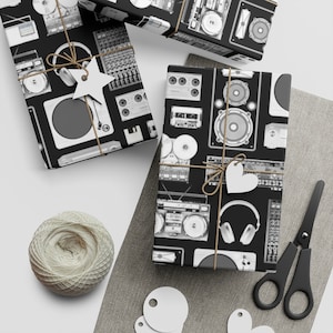 May include: Black and white wrapping paper with a repeating pattern of vintage audio equipment, including cassette players, turntables, speakers, and headphones.