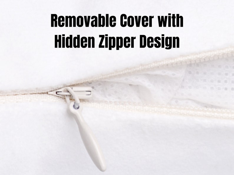 May include: A white zipper with a white pull tab. The zipper is partially open, revealing a white fabric with a small, white, dotted pattern. The text "Removable Cover with Hidden Zipper Design" is visible above the zipper.