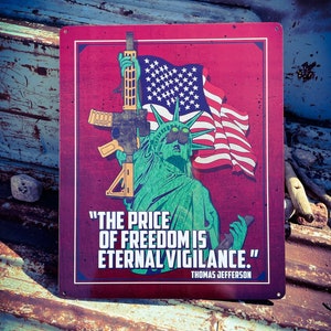 May include: A red metal sign with a green Statue of Liberty holding a rifle and a US flag. The sign reads "The price of freedom is eternal vigilance." - Thomas Jefferson.