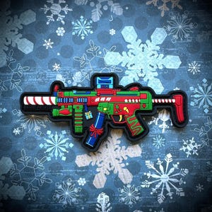 May include: A Christmas-themed toy gun patch with a candy cane barrel, red and green accents, and the text "PATRIOT PATCH CO."