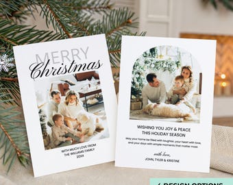 May include: Two white Christmas cards with family photos. One card reads "Merry Christmas" and "With much love from The Williams Family 20XX." The other card says "Wishing you joy & peace this holiday season."