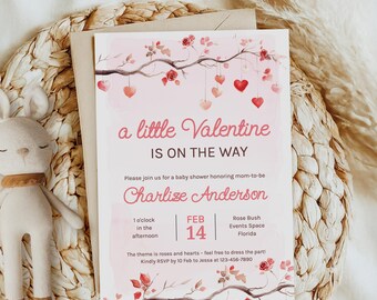 May include: A pink baby shower invitation featuring a watercolour illustration of a branch with red roses and pink hearts hanging from it. The text reads "a little Valentine is on the way" and includes the name "Charlize Anderson", the date "Feb 14", and the time "1 o'clock in the afternoon".