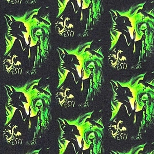 May include: A black and green fabric with a repeating pattern of a silhouette of a witch holding a staff with a glowing orb at the top. The witch is surrounded by small, yellow dragons.