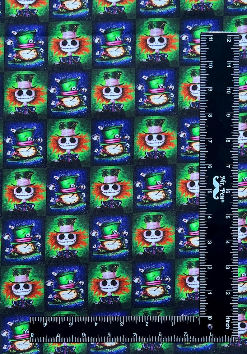 May include: A repeating pattern fabric featuring a green, blue, and black background with a cartoon character wearing a green hat and a red and white striped shirt. The character has a skull-like face with a wide grin. The fabric is perfect for crafting projects.