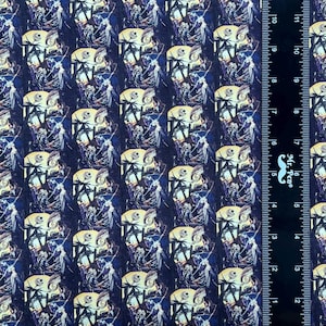 May include: A repeating pattern fabric featuring a colorful illustration of Jack Skellington from the Nightmare Before Christmas movie. The fabric is dark blue with a repeating pattern of Jack Skellington and Sally in the background.