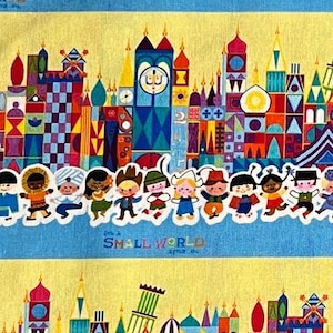 May include: A colorful fabric featuring a repeating pattern of a whimsical cityscape with a blue sky and yellow background. The cityscape is made up of colorful buildings with geometric shapes and patterns. The text "It's a Small World" is printed in white on a blue banner.