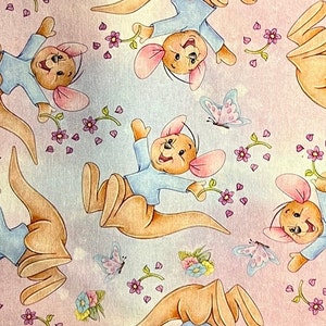 May include: A pink and blue fabric with a repeating pattern of cartoon kangaroos wearing blue shirts and holding flowers. The kangaroos have brown fur and large ears. There are also butterflies and flowers in the pattern.