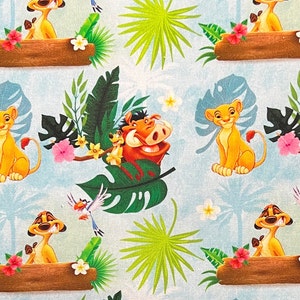 May include: A blue and green fabric with a repeating pattern of cartoon animals from the Lion King movie. The animals include Simba, Pumbaa, and Timon. The fabric also features tropical plants and flowers.