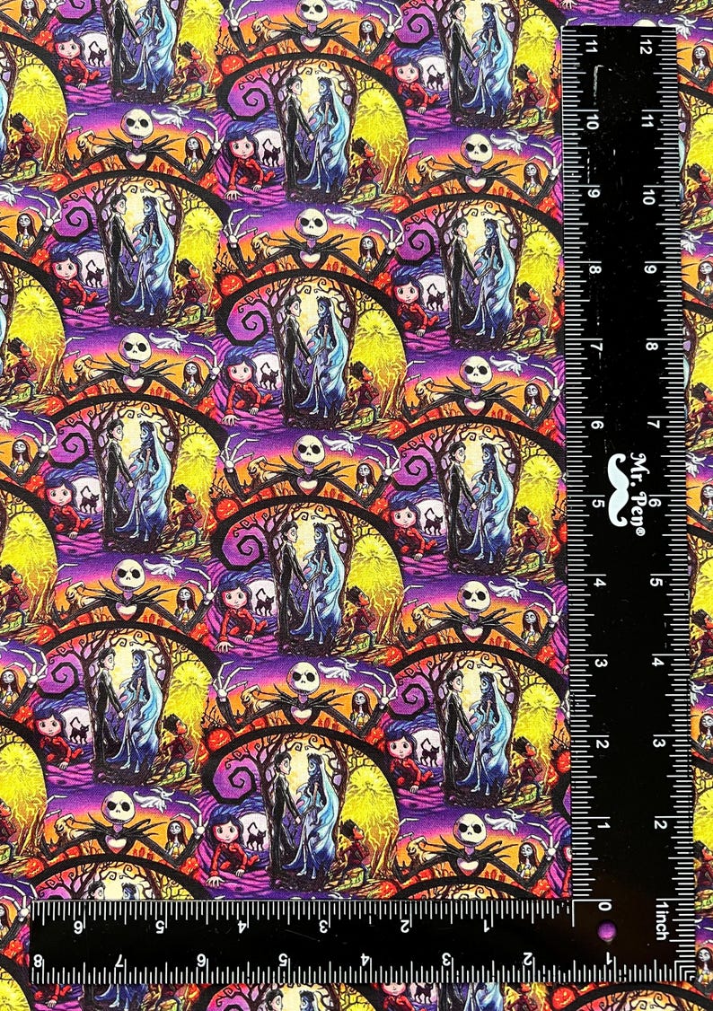 May include: A colorful fabric with a repeating pattern of Jack Skellington and Sally from the Nightmare Before Christmas. The pattern is on a purple background with yellow, orange, and black accents. The fabric is measured with a ruler in inches.