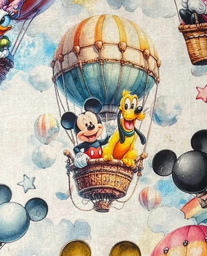 May include: A whimsical fabric design featuring Mickey Mouse and Pluto in a hot air balloon. The balloon is a mix of blue, orange, and tan, with a woven basket. The background includes clouds, stars, and other balloons, creating a cheerful, cartoon-like scene.