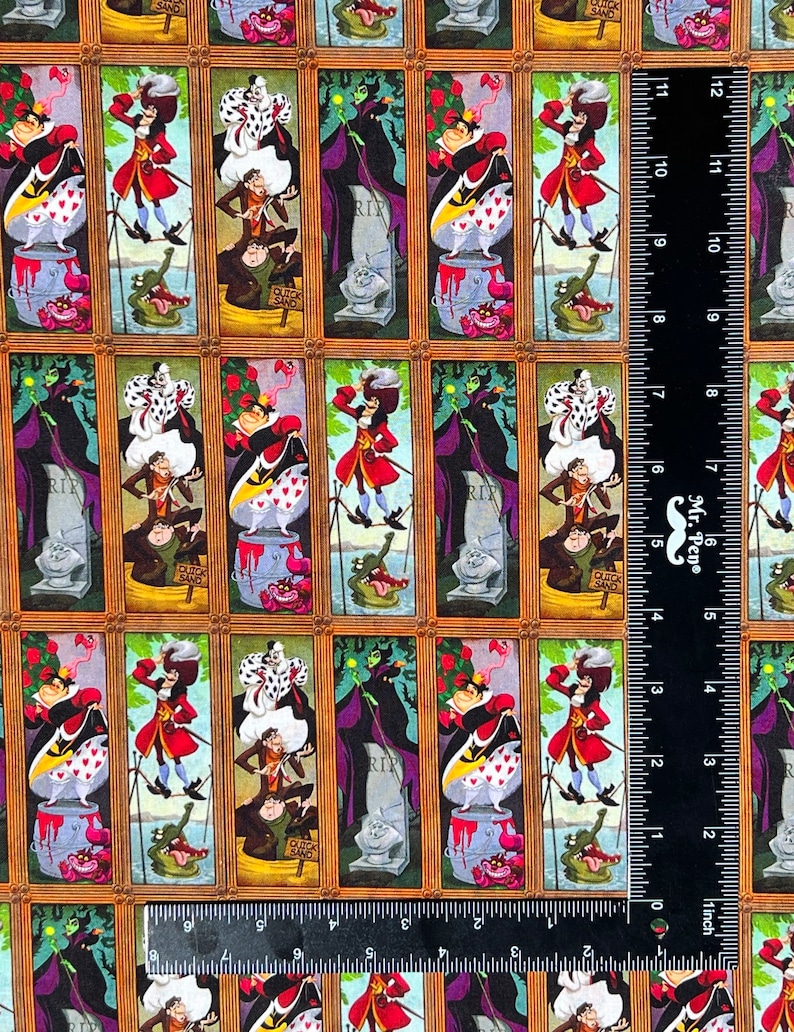 May include: Fabric featuring framed portraits of Disney villains and characters. The portraits include the Queen of Hearts, Captain Hook, and the Evil Queen. The background is a tan color with a repeating pattern of the framed portraits.