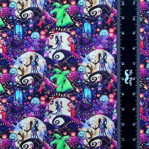 May include: A colorful fabric with a repeating pattern of characters from the movie The Nightmare Before Christmas. The characters include Jack Skellington, Sally, and Oogie Boogie. The fabric is a dark purple color with a variety of other colors, including green, orange, and pink.