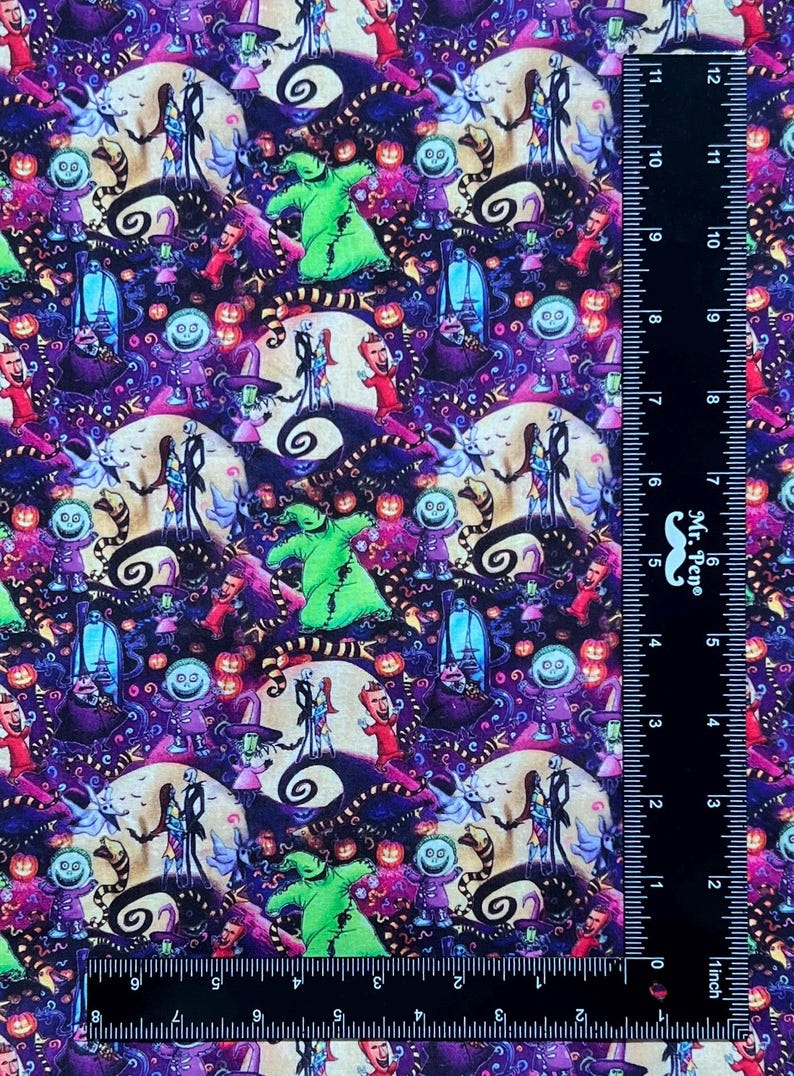 May include: A colorful fabric with a repeating pattern of characters from the movie The Nightmare Before Christmas. The characters include Jack Skellington, Sally, and Oogie Boogie. The fabric is a dark purple color with a variety of other colors, including green, orange, and pink.