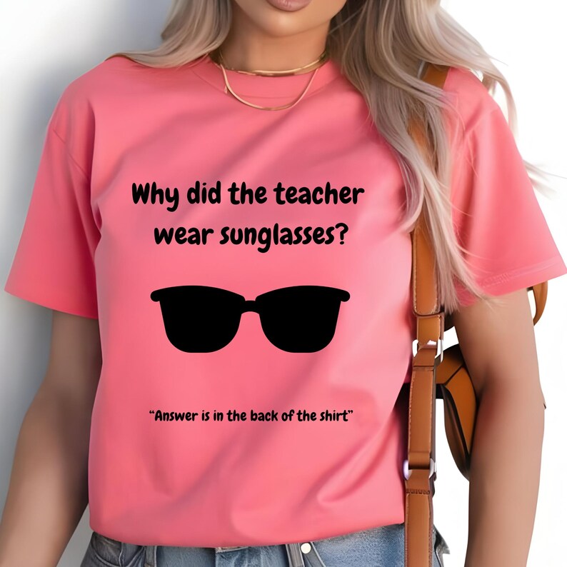 Funny Teacher T-Shirt, "Bright Students" Graphic Tee, Unisex Shirt with Quote: Why did the teacher wear sunglasses? a black sunglasses is designed in the apparel. *Answer is in the back of the shirt - Because her students sere so bright! Female model wearing blossom color t-shirt.
