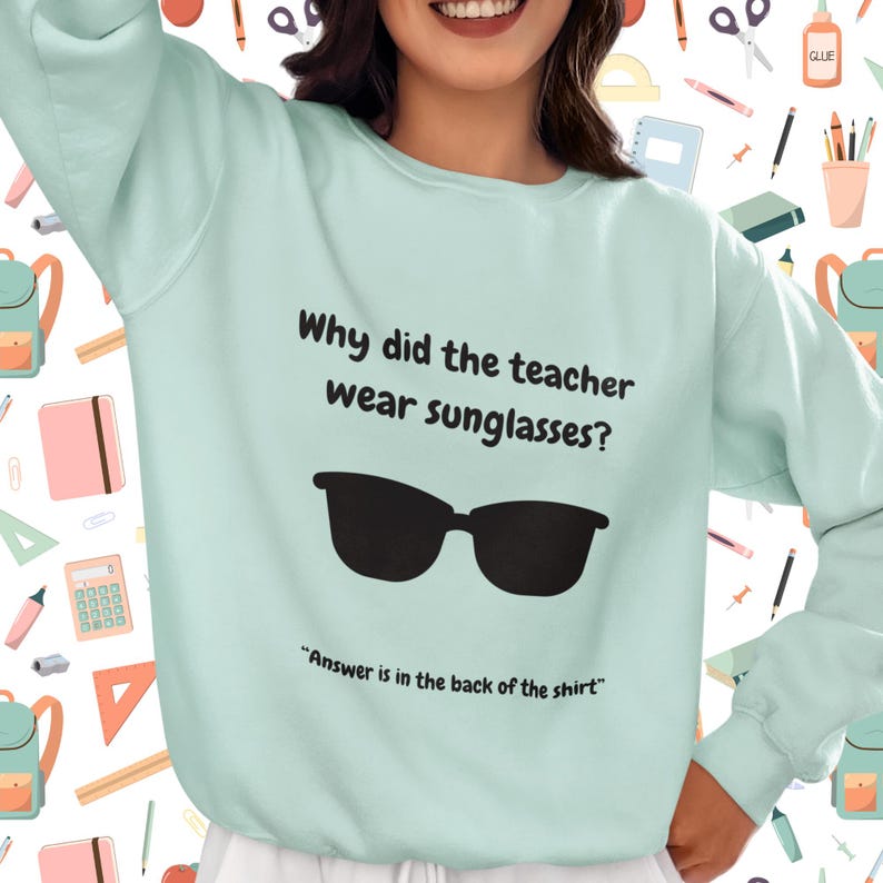 Funny Teacher Sweatshirt, "Bright Students" Graphic Pullover, Unisex Cozy Apparel with Quote: Why did the teacher wear sunglasses? a black sunglasses is designed in the apparel. *Answer is in the back of the shirt - Because her students sere so bright! Female model wearing agave color sweatshirt.
