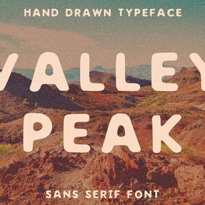 May include: Hand-drawn sans serif font called "Valley Peak" in white letters against a background of a desert landscape with brown and green hills.