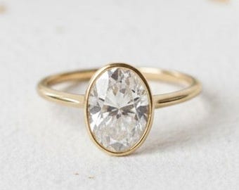 Massief gouden ovale moissaniet verlovingsring - ringset