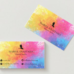 May include: A business card with a watercolor background in shades of yellow, pink, and blue. The card features a black silhouette of a dragon and the text "ISABELL ANASTASIA Pottery Studio". Contact information is listed below, including a phone number, email address, and website.