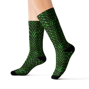 May include: Green dragon scale patterned socks. The socks are black with a green dragon scale pattern.